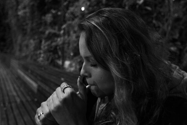a woman smoking cbd edibles to manage her anxiety